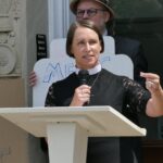 A woman in a black religious dress with a white collar